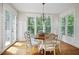Bright dining room with wood floors, large windows and French doors leading to an outdoor space at 113 Stargaze Rdg, Canton, GA 30114