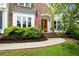 Inviting front entrance with a charming brick walkway, a wood door, and manicured bushes at 113 Stargaze Rdg, Canton, GA 30114