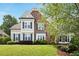 Charming two-story home featuring a brick facade, light blue accents, and a well-manicured lawn at 113 Stargaze Rdg, Canton, GA 30114