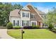 Beautiful home showcasing a lush green lawn and a welcoming brick and siding exterior at 113 Stargaze Rdg, Canton, GA 30114
