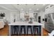 Modern kitchen featuring a large island with seating, stainless steel appliances, and stylish pendant lighting at 113 Stargaze Rdg, Canton, GA 30114