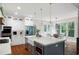Bright kitchen with a large island, modern appliances, and a dining area near the windows at 113 Stargaze Rdg, Canton, GA 30114