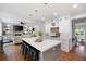 Spacious, open-concept kitchen with a large island and modern white cabinets, seamlessly flowing into the living area at 113 Stargaze Rdg, Canton, GA 30114
