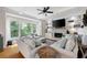 Comfortable living room features a fireplace, large windows, and cozy seating, offering a relaxing space at 113 Stargaze Rdg, Canton, GA 30114
