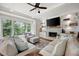 Comfortable living room with a fireplace, built-in shelving, and large windows overlooking the yard at 113 Stargaze Rdg, Canton, GA 30114