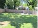 Spacious backyard with lush green grass, a wooden fence, and a gravel firepit area at 123 Dahlgren St, Atlanta, GA 30317