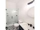 Modern bathroom featuring a glass enclosed shower with black hardware and patterned tile flooring at 123 Dahlgren St, Atlanta, GA 30317