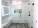 Luxurious bathroom features marble-tiled walls, a modern shower with a rainfall showerhead and a built-in bench at 123 Dahlgren St, Atlanta, GA 30317