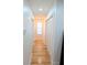 Well-lit hallway with hardwood floors and a closet for storage in a modern home at 123 Dahlgren St, Atlanta, GA 30317