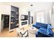 Bright living room features a stylish blue velvet sofa, hardwood floors, and modern décor, creating a cozy atmosphere at 123 Dahlgren St, Atlanta, GA 30317