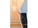 A staircase with light wood treads and a black metal railing leading to the upper level at 123 Dahlgren St, Atlanta, GA 30317