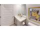 Half bathroom featuring vanity, sink, and toilet, with art and a mirror on the walls at 251 Eason St, Bowdon, GA 30108
