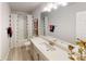 Well-lit bathroom featuring a shower with curtain, a vanity with drawers, and modern decor at 251 Eason St, Bowdon, GA 30108