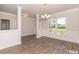 Bright dining room with hardwood floors, wainscoting, large window, and elegant chandelier at 251 Eason St, Bowdon, GA 30108