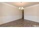 Dining room with wood flooring, wainscoting and chandelier lighting at 251 Eason St, Bowdon, GA 30108