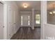 Welcoming foyer with hardwood floors, transom window, and decorative columns, offering a seamless transition at 251 Eason St, Bowdon, GA 30108