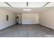 A spacious two car garage with painted walls and concrete flooring at 251 Eason St, Bowdon, GA 30108