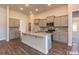 Modern kitchen with gray cabinets, granite countertops, stainless steel appliances, and center island at 251 Eason St, Bowdon, GA 30108