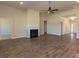 Spacious living room with hardwood floors, fireplace, ceiling fan, and ample natural light at 251 Eason St, Bowdon, GA 30108