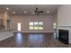 Open concept living room with hardwood floors, fireplace, and large windows overlooking the backyard at 251 Eason St, Bowdon, GA 30108