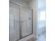 Bathroom featuring a glass enclosed shower and soaking tub with a window at 259 Eason St, Bowdon, GA 30108