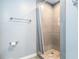 Bathroom featuring a neutral-toned tile shower with glass door and modern fixtures at 2063 Willow Chase Ct, Tucker, GA 30084