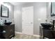 Gray bathroom with modern sinks, tiled floors, and decorative mirrors at 2063 Willow Chase Ct, Tucker, GA 30084