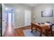 Bedroom with hardwood floors, large windows, area rug, and simple office setup at 2063 Willow Chase Ct, Tucker, GA 30084