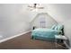 Cozy bedroom features a ceiling fan, plush carpet, sloped ceiling, and a bed with blue comforter at 2063 Willow Chase Ct, Tucker, GA 30084