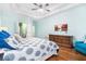 Bright main bedroom features a tray ceiling, hardwood floors, and a comfortable seating area at 2063 Willow Chase Ct, Tucker, GA 30084