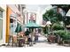 Outdoor dining area with umbrellas, tables, and chairs on a sunny day at a shopping mall at 2210 Park Walke Dr, Alpharetta, GA 30009