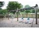 Swings hanging from a wooden frame are ready for park visitors at 2210 Park Walke Dr, Alpharetta, GA 30009