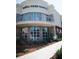 Exterior shot of a modern Whole Foods Market with a curved facade, brick accents, and green landscaping at 2210 Park Walke Dr, Alpharetta, GA 30009