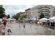 Children playing in the splash fountain with community businesses and living available in the background at 2285 Park Walke Dr, Alpharetta, GA 30009