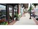 Retail shopfront and street view with tables, potted plants, and pedestrians in a walkable neighborhood at 2285 Park Walke Dr, Alpharetta, GA 30009