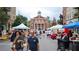 A bustling town square with local shops, a grand building, and people enjoying an outdoor market at 2285 Park Walke Dr, Alpharetta, GA 30009
