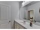 Bathroom with white vanity, sink, and large mirror, featuring a neutral color scheme and plenty of space at 4825 Odum View Ln, Cumming, GA 30040