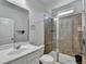 Bathroom with a glass-enclosed shower, vanity with sink, toilet, and tiled shower at 4825 Odum View Ln, Cumming, GA 30040