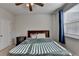 Inviting bedroom with a ceiling fan, natural light, and neutral décor at 4825 Odum View Ln, Cumming, GA 30040