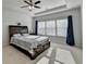 Large primary bedroom with ceiling fan and trey ceiling has plenty of natural light at 4825 Odum View Ln, Cumming, GA 30040