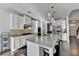 Eat-in kitchen showcases granite countertops, stainless appliances, and an island with bar stool seating at 4825 Odum View Ln, Cumming, GA 30040