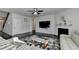 Bright living room featuring a white fireplace, flat screen tv, and a plush rug at 4825 Odum View Ln, Cumming, GA 30040