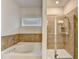 Modern bathroom featuring a separate tub and tiled glass shower at 4825 Odum View Ln, Cumming, GA 30040