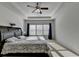 Main bedroom with natural light, decorative tray ceiling and fan, with nice size windows at 4825 Odum View Ln, Cumming, GA 30040