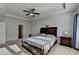Spacious main bedroom with tray ceiling, fan, and ensuite access at 4825 Odum View Ln, Cumming, GA 30040