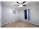 Bedroom featuring neutral paint, ceiling fan, tan carpet, and window providing natural light at 6487 Northridge Way, Morrow, GA 30260