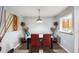 The dining room features modern decor and a passthrough window to the kitchen at 6487 Northridge Way, Morrow, GA 30260