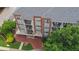 Elevated view of a condominium featuring manicured landscaping, brick accents, and balcony units at 840 United Ave # 113, Atlanta, GA 30312