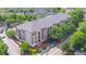 Aerial view of a stately four-story condominium, surrounded by lush greenery and mature trees at 840 United Ave # 113, Atlanta, GA 30312