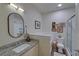 Well-lit bathroom with granite countertop, a framed mirror, and a glass-enclosed shower at 840 United Ave # 113, Atlanta, GA 30312